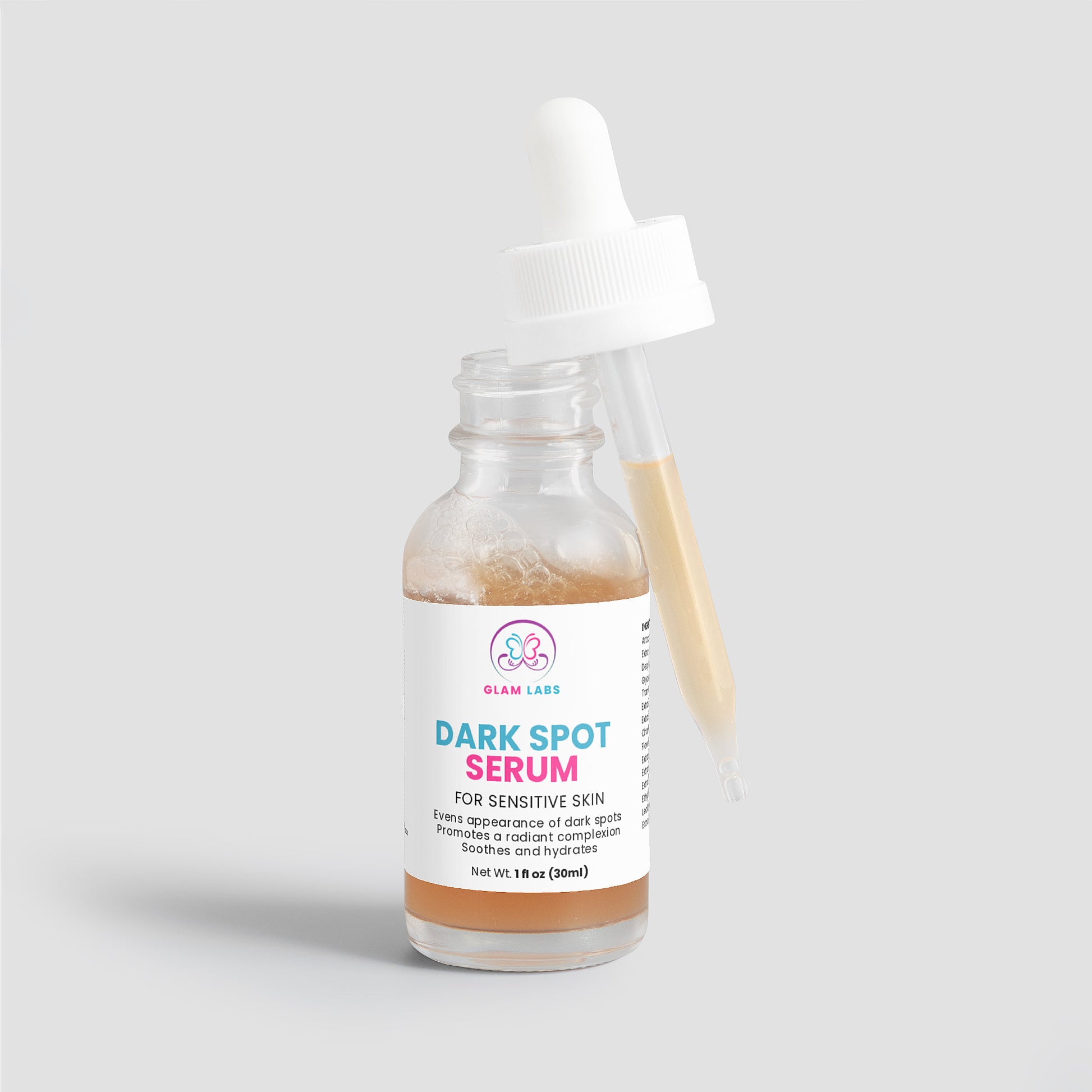 Glam Labs glass dropper bottle of Dark Spot Serum for Sensitive Skin with amber serum and white label