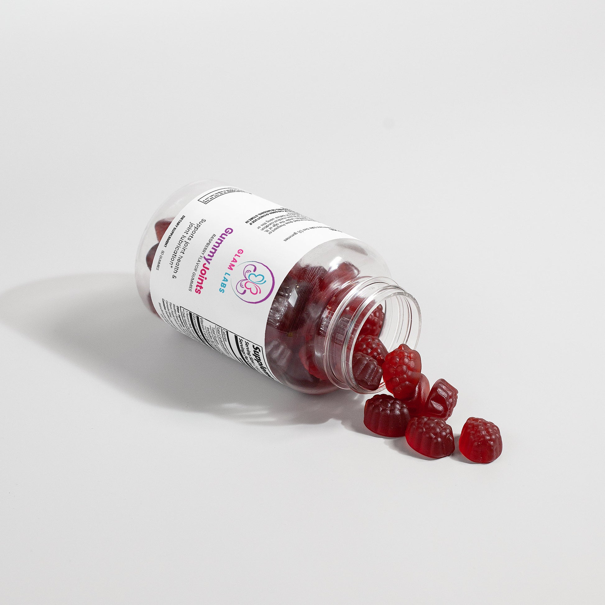 GlamLabs Gummies for Healthy Joints spilling from clear bottle Supplements for Joint Pain Relief and Mobility