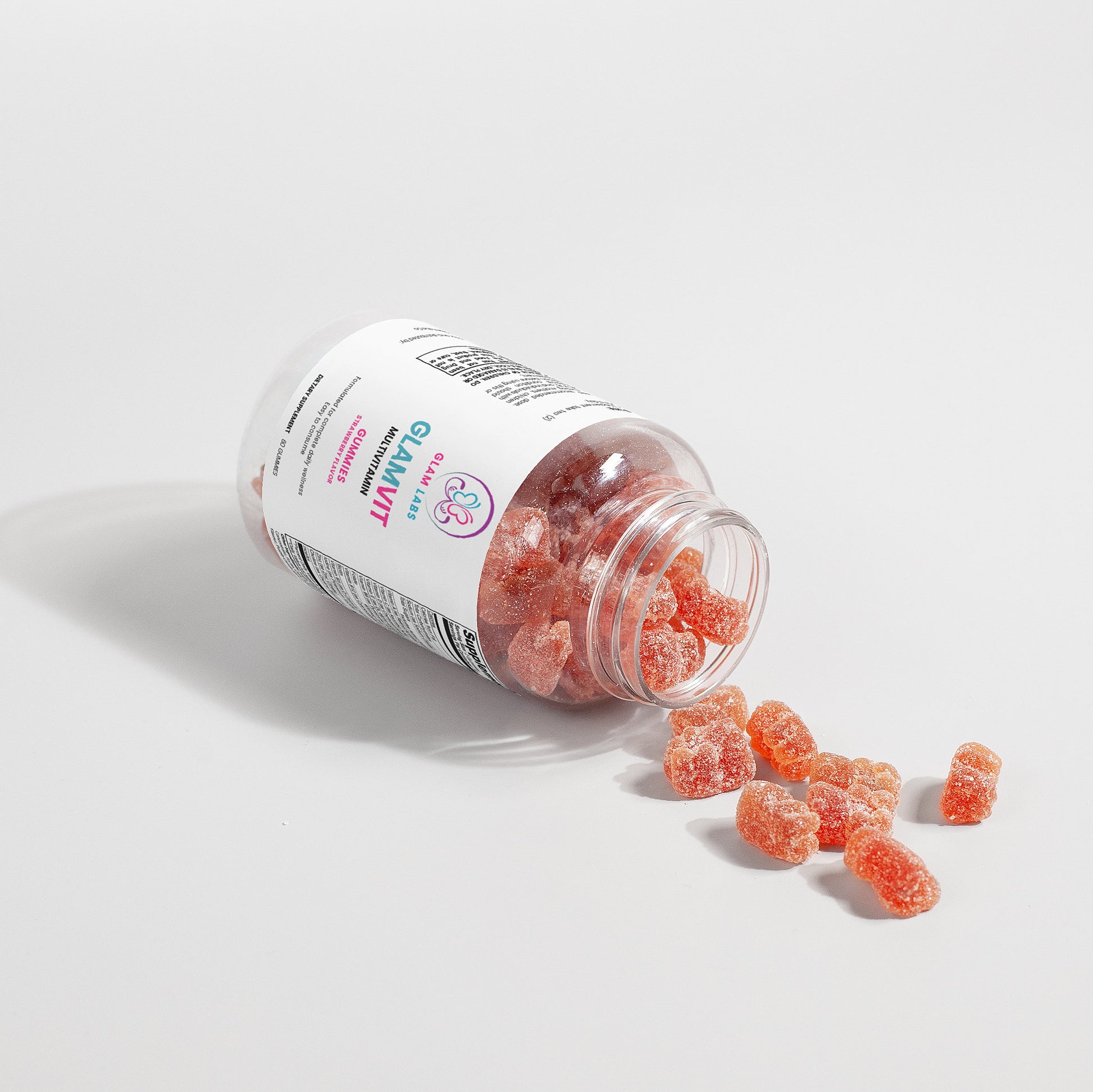 GlamLabs multi vitamin gummies spilling from a clear bottle showcasing multi vitamin supplements